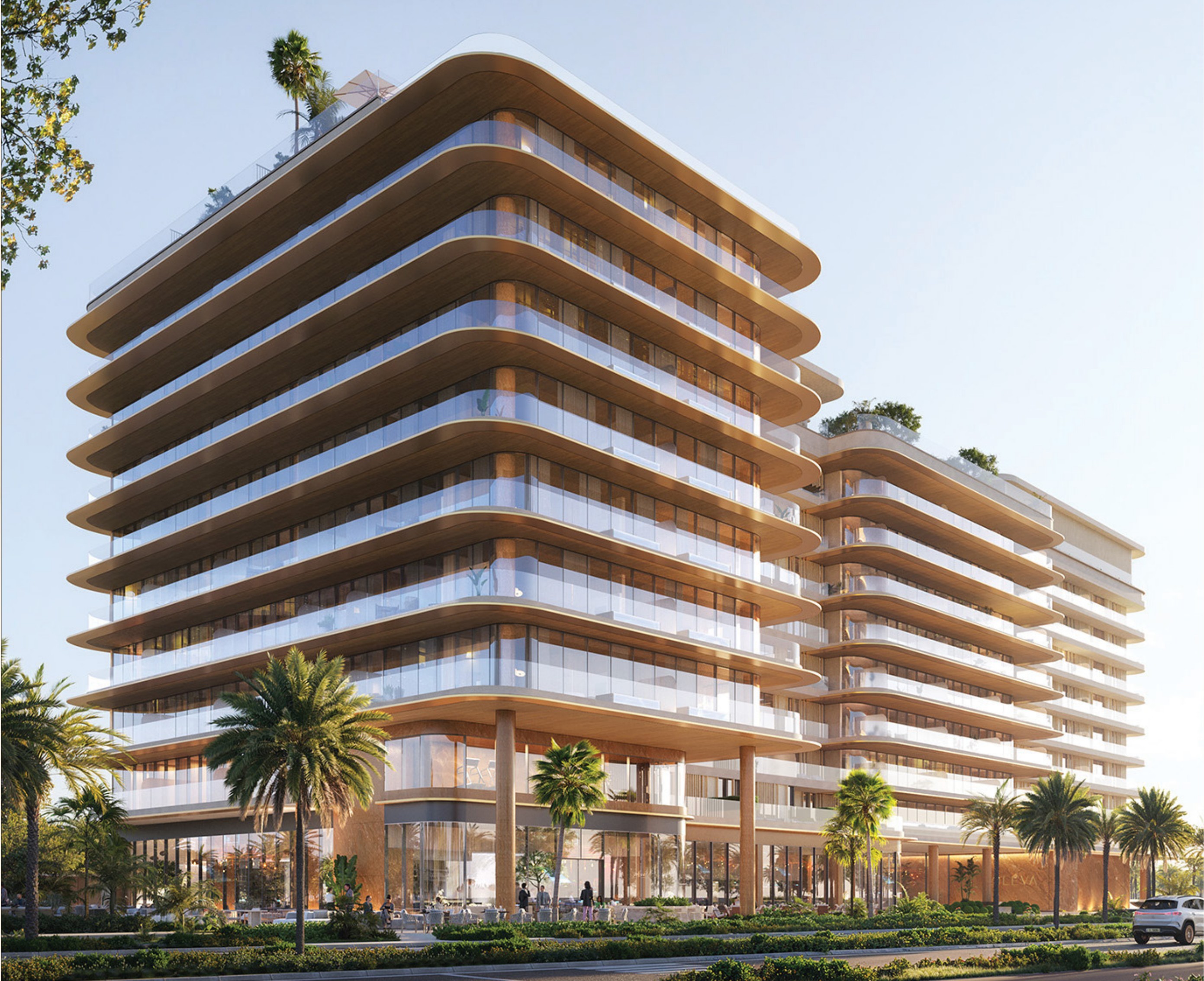 Daylight view of the Soléva facade with stacked curved balconies among palms